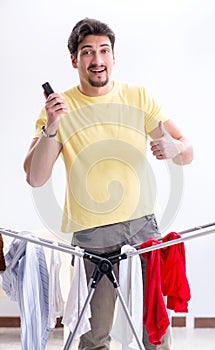 Handsome man husband doing laundering at home