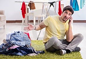 Handsome man husband doing laundering at home