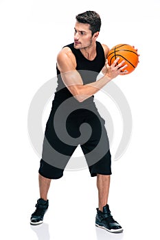 Handsome man im sports wear playing in basketball