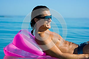 Handsome man on inflatable raft