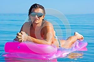 Handsome man on inflatable raft
