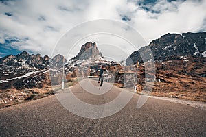 Handsome man jumping amazing mountains background