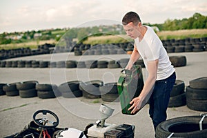 Handsome man in a karting with a car