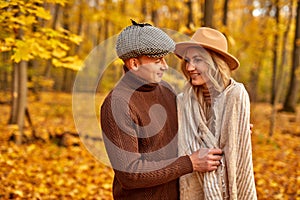 Handsome man is kind to his wife, love story in autumn forest or park