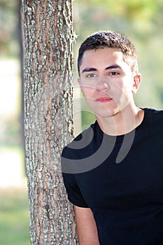 Handsome Man Leaning on a Tree