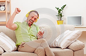 Handsome man listening to music at home