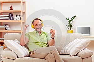 Handsome man listening to music at home