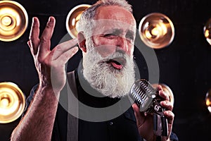 Handsome man with long beard in shirt raised one hand up isolate