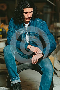 Handsome man with long hair brunette in a denim jacket