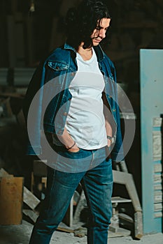 Handsome man with long hair brunette in a denim jacket