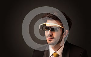 Handsome man looking with futuristic high tech glasses
