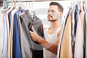 Handsome man looking at his closet photo