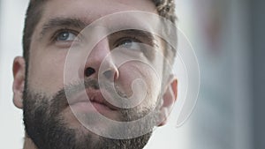 Handsome man looking at scoreboard, last decisive minutes in sport competition