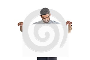 Handsome man looking at white blank sheet