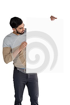 Handsome man looking at white blank sheet