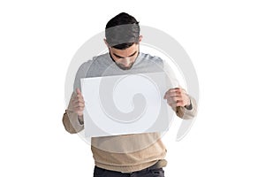 Handsome man looking at white blank sheet