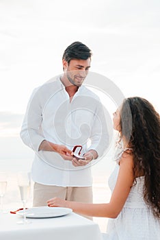handsome man making propose with ring to girlfriend