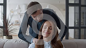 Handsome man massaging woman shoulders in slow motion. Couple hugging together