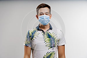 Handsome man in medical mask isolated on white background. Coronavirus covid-19 quarantine concept