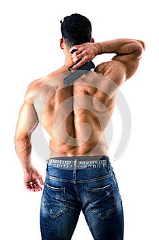 Handsome man with naked muscular torso holding hand gun