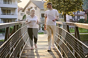 A handsome man and an older woman share a serene walk in nature, crossing a beautiful bridge against the backdrop of a