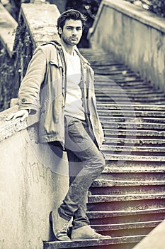 Handsome man on outdoor old staircase