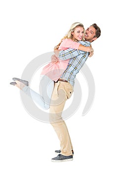 Handsome man picking up and hugging his girlfriend