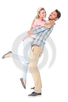 Handsome man picking up and hugging his girlfriend