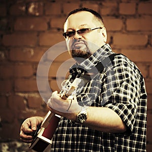 Handsome man playing his cigar box guitar