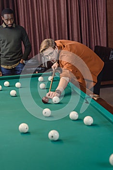 handsome man playing in pool at bar