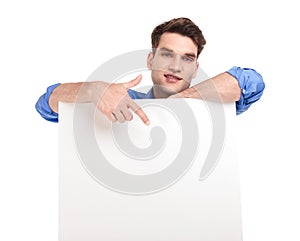 Handsome man pointing his finger to a white board.