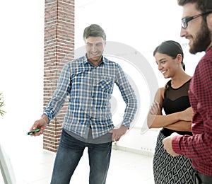 Handsome man is pointing to the whiteboard in office