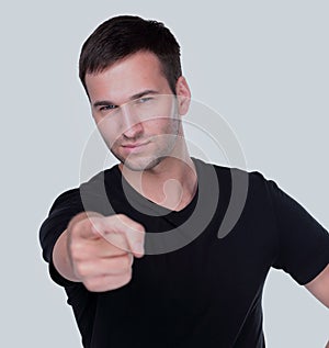 Handsome man points his finger at you