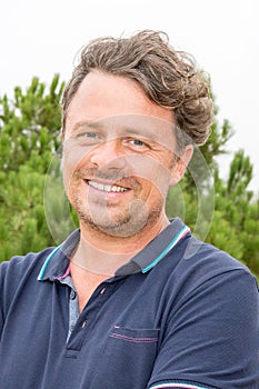 Handsome man portrait middle aged smiling in summer day outdoor