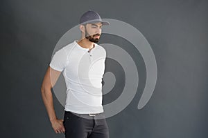 Handsome man posing against grey background