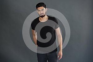 Handsome man posing against grey background