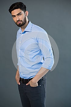 Handsome man posing against grey background