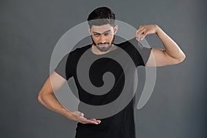 Handsome man posing against grey background