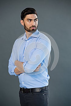 Handsome man posing against grey background