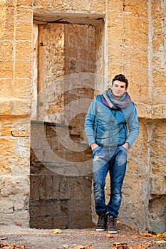 Handsome man posing against grunge ruins.