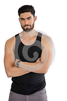 Handsome man posing with arms crossed against white background