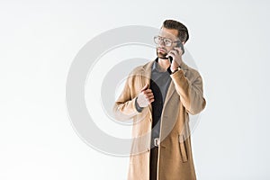 handsome man posing in autumn outfit talking on smartphone