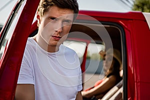 Handsome man posing near car