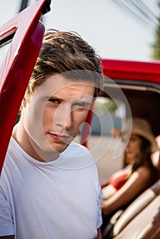 Handsome man posing near car