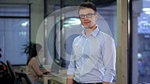 Handsome man posing on office background, official employment, business career