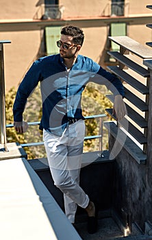 Handsome man posing outdoor in summer clothes