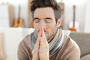 handsome man praying at home