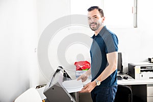 Handsome man printing labels