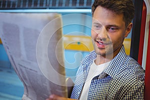 Handsome man reading newspaper