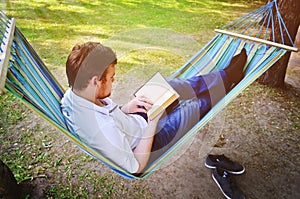 A handsome man reads a book